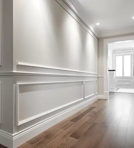 Painted wainscoting and baseboards in luxury hallway